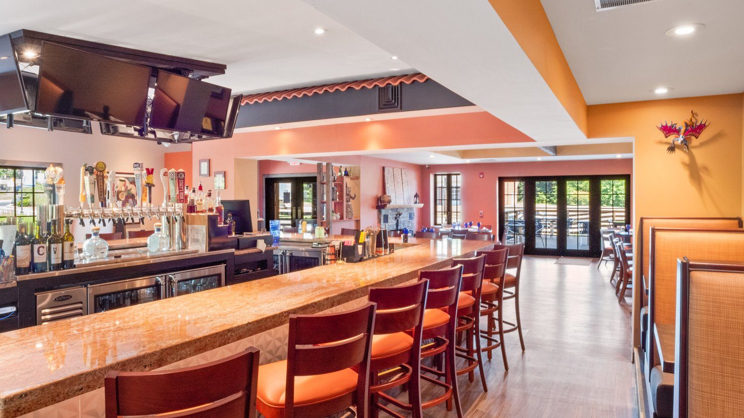 The bar from the other end, taps and bottles behind
