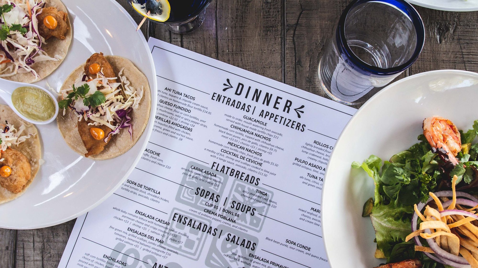 Fish tacos beside the printed dinner menu