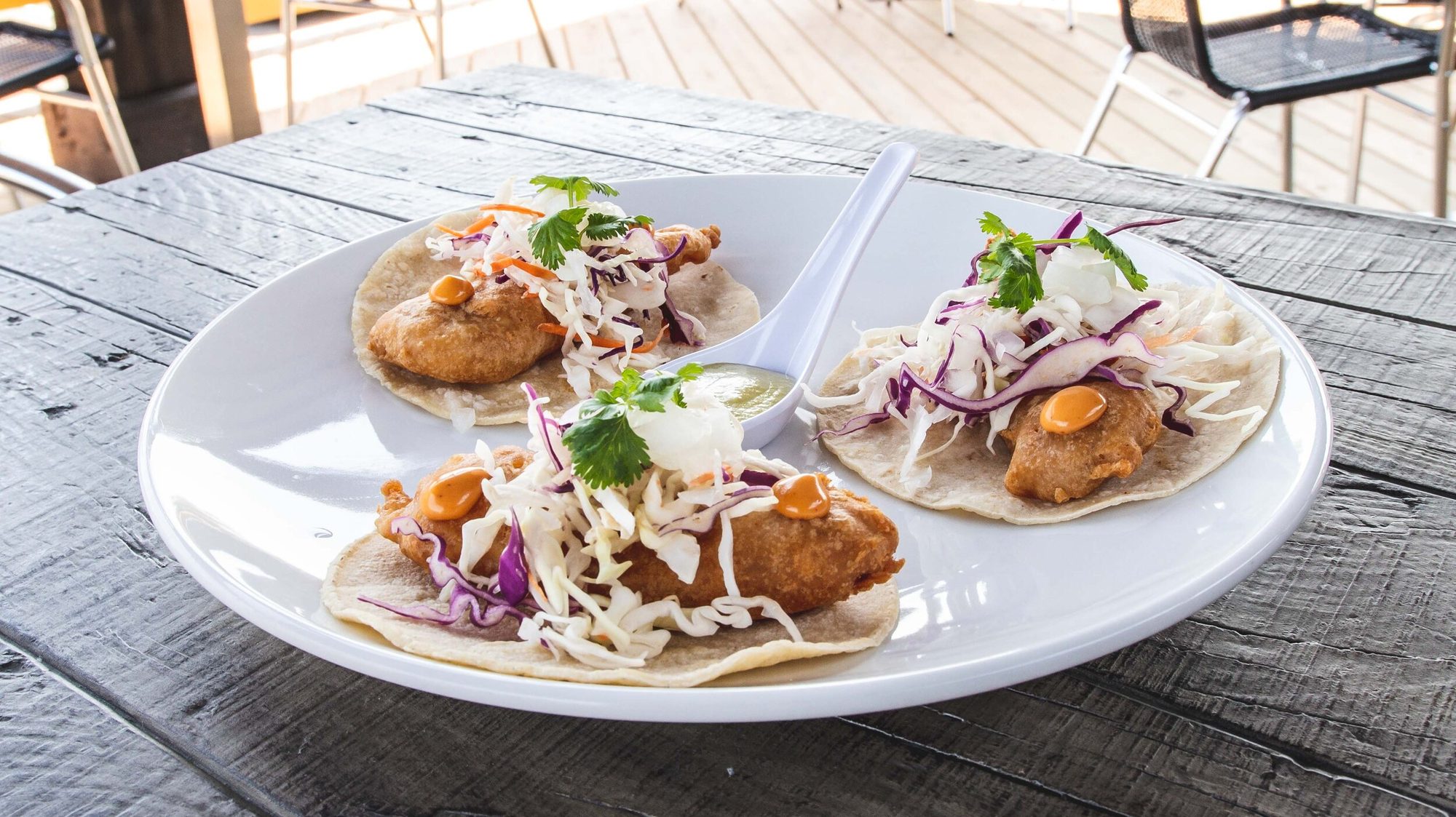 Fish tacos on a table out on the patio