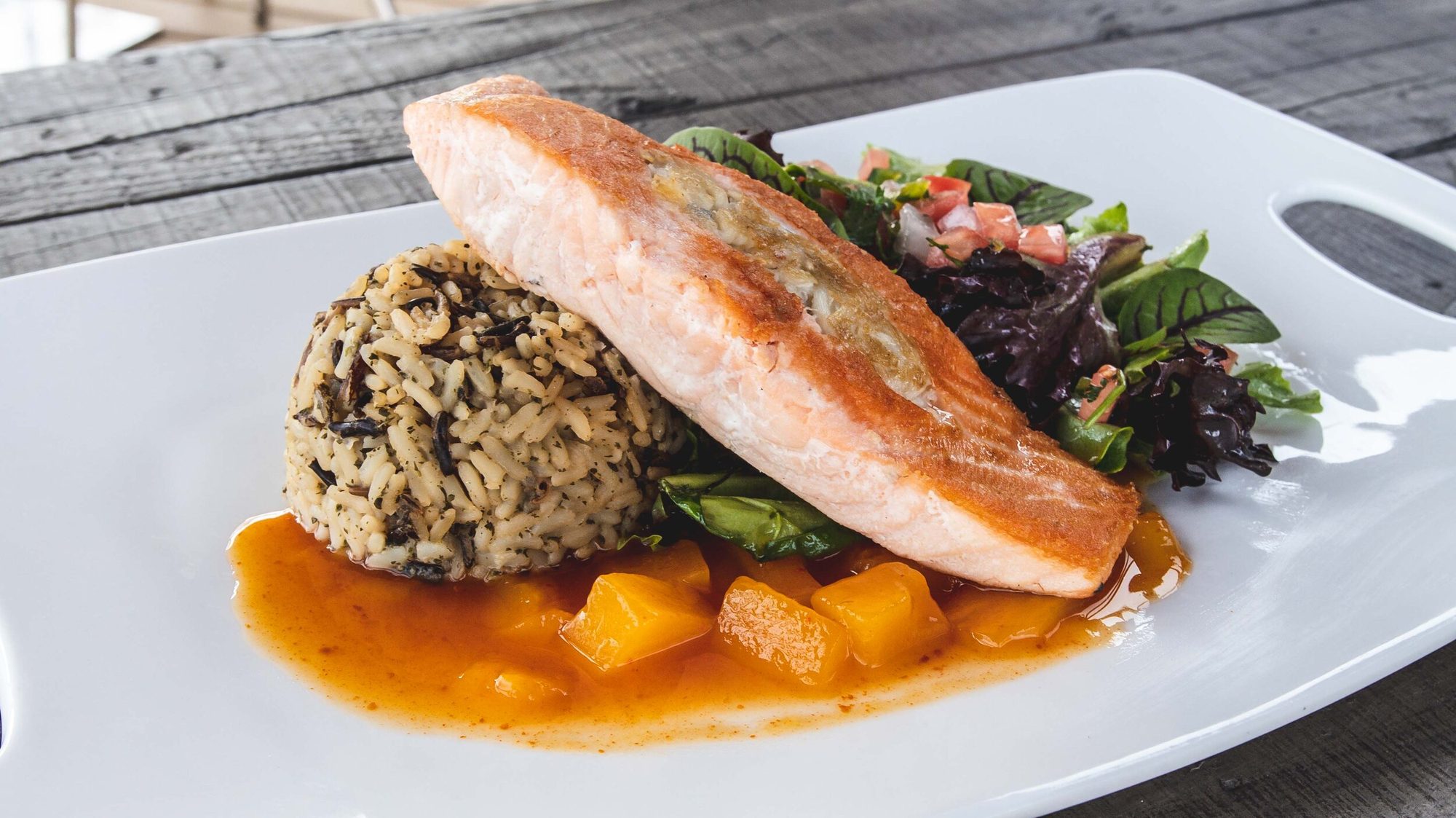 Salmon and rice plated on a board