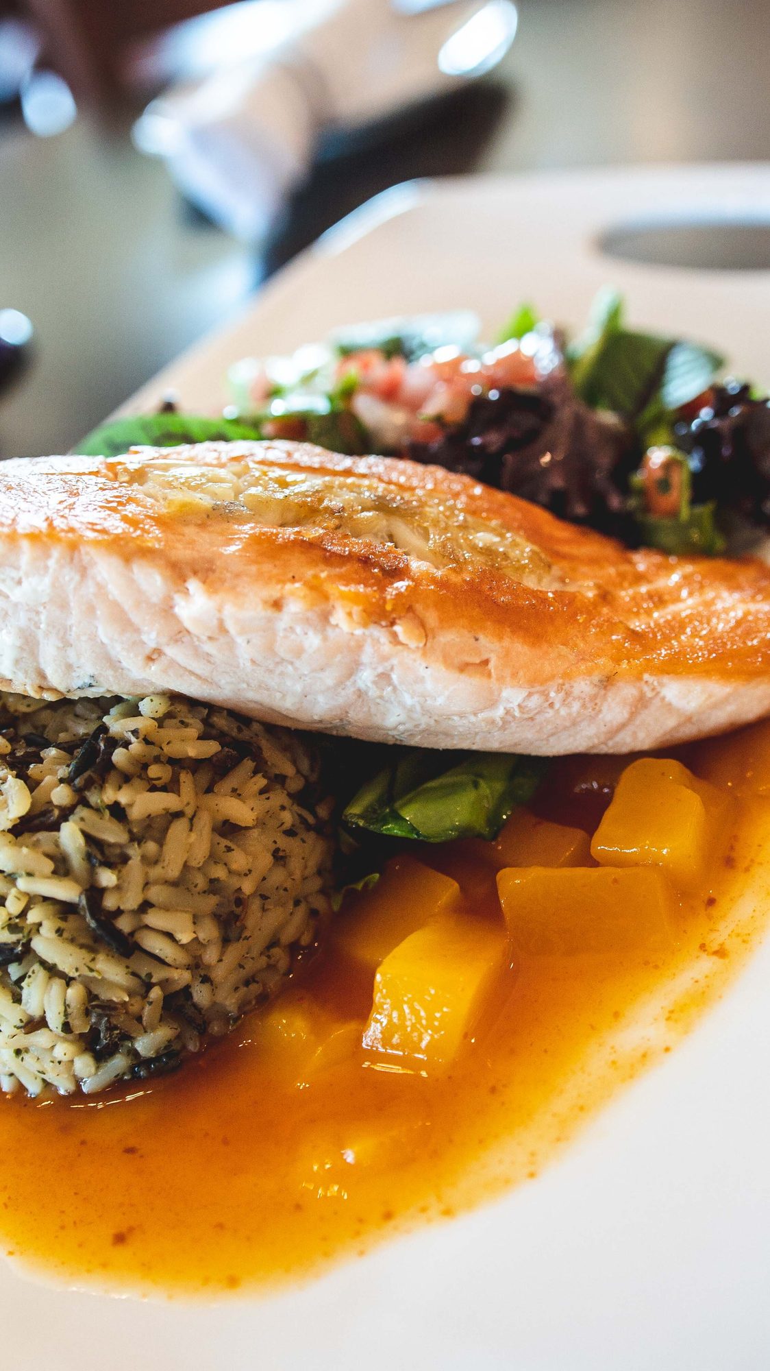 Salmon over rice in a pool of sauce