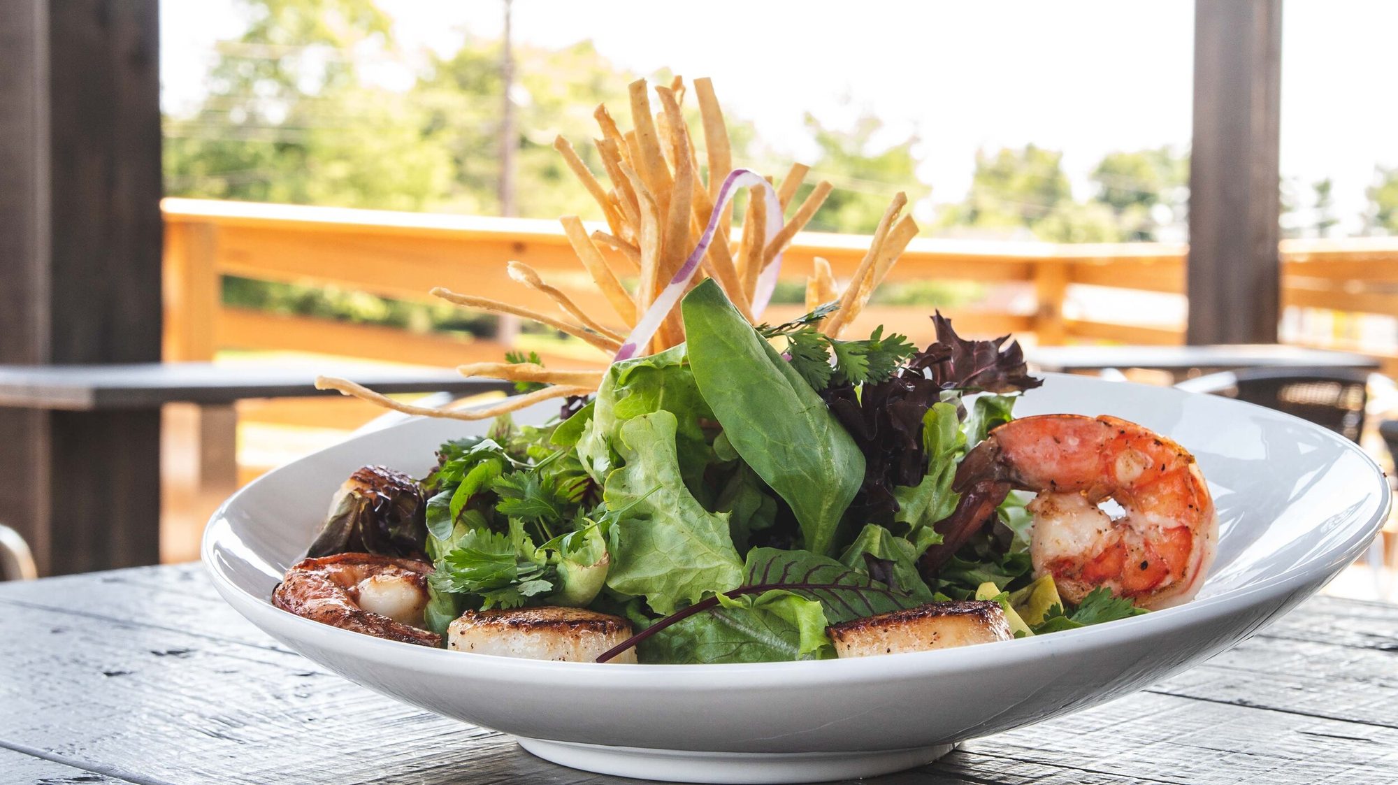Shrimp and scallop salad on a patio table