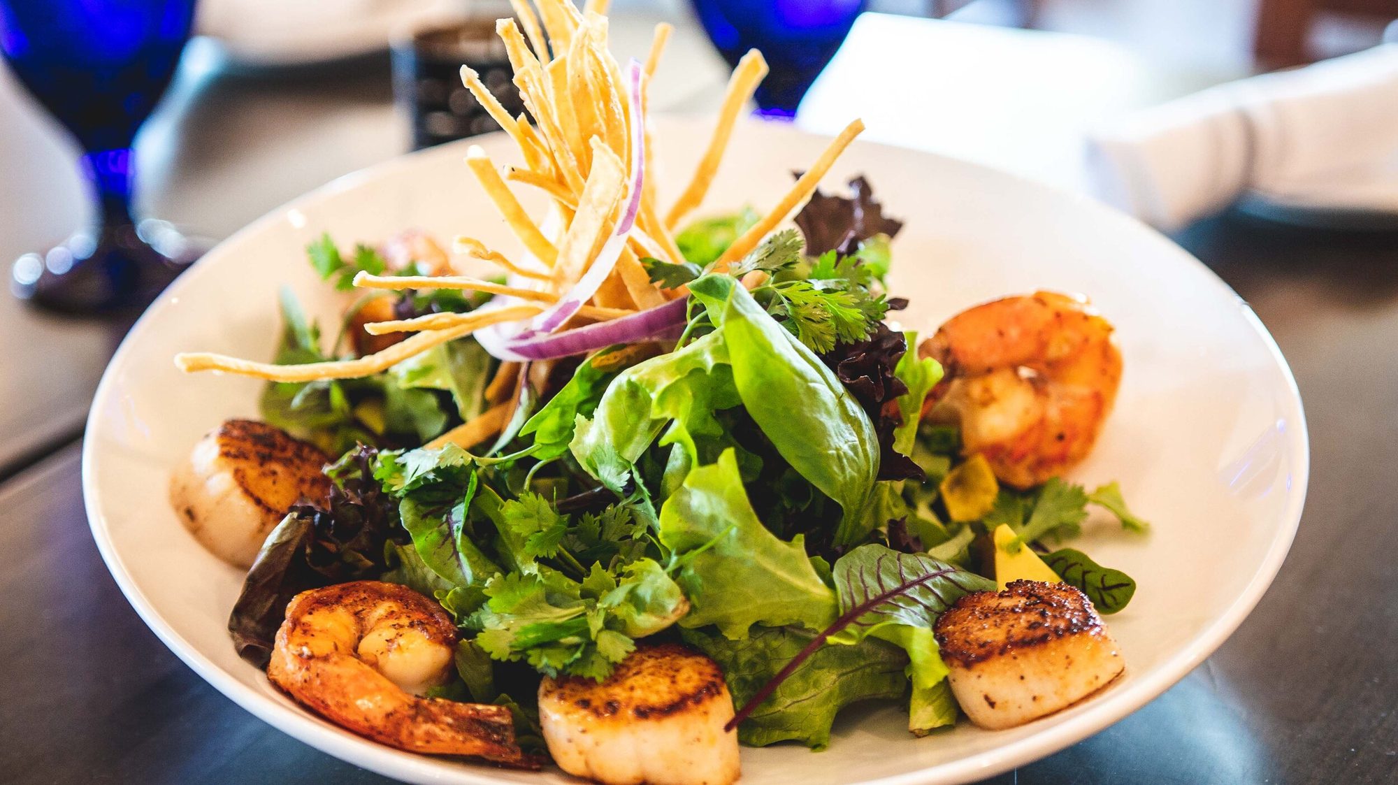 Shrimp and scallop salad, crisp tortilla threads on top