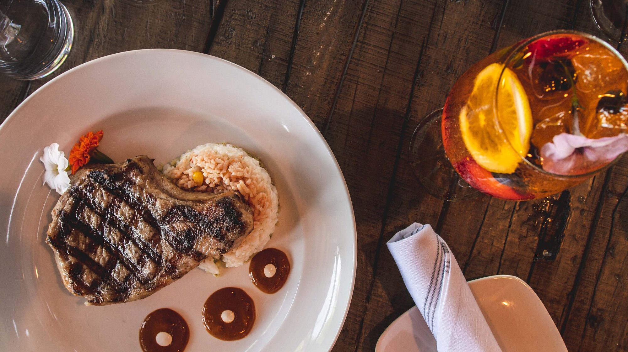 Grilled steak with rice and a cocktail alongside