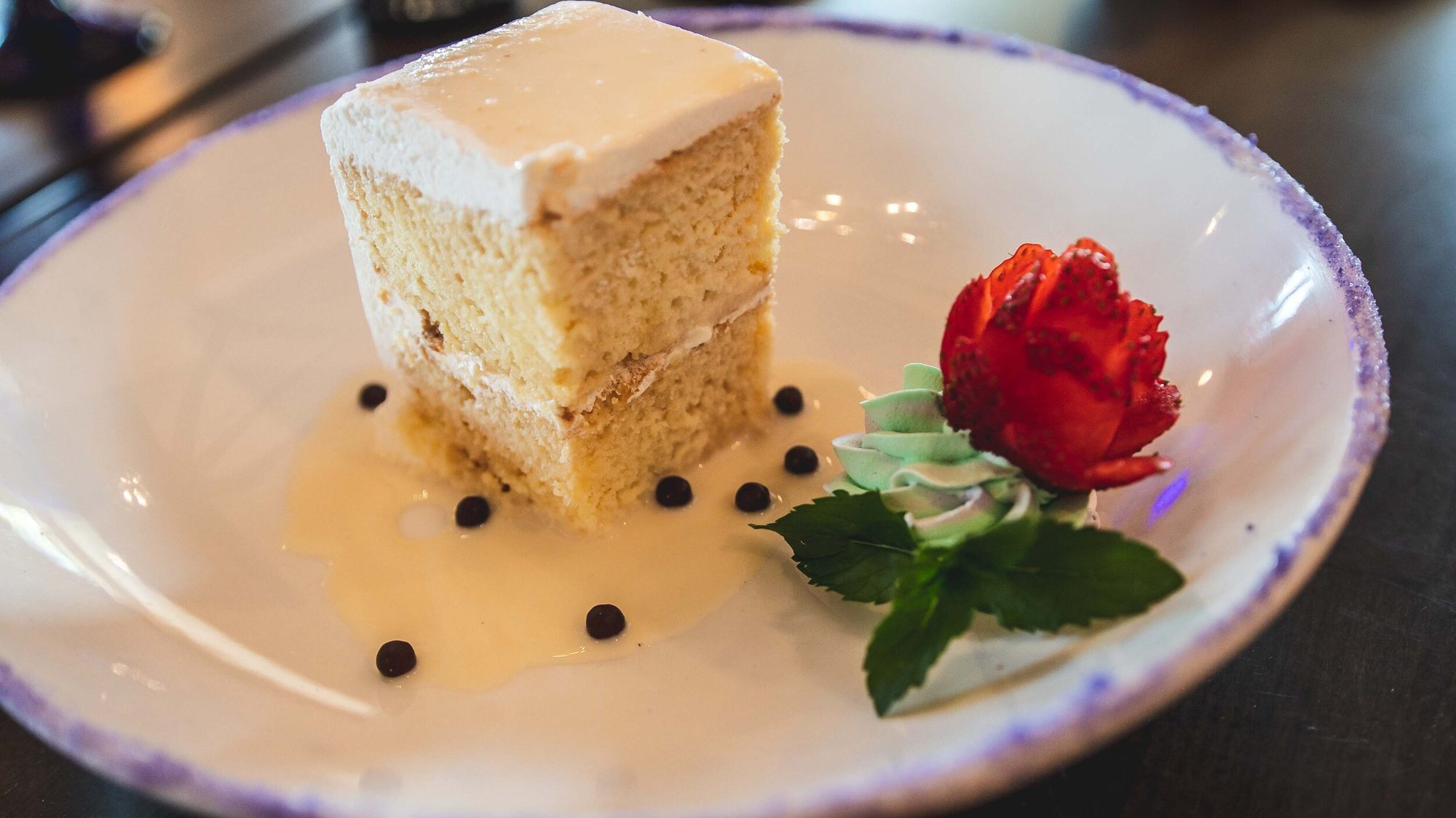 Tres leches cake with a carved rose and mint