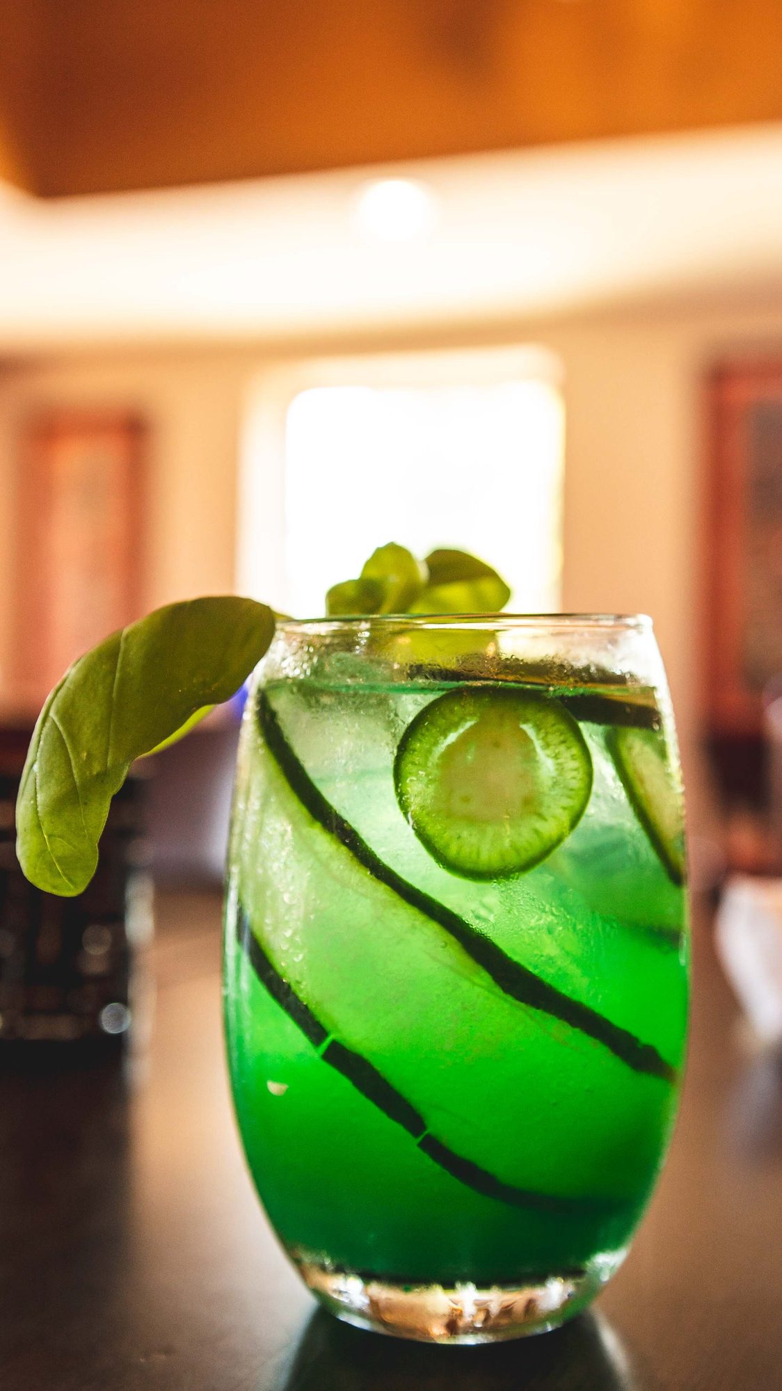 A green margarita over ice with lime and a salted rim