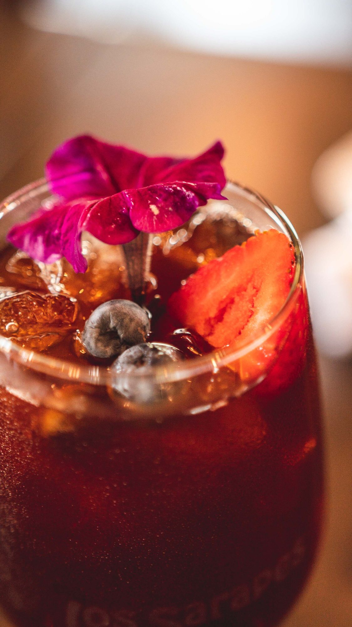 Sangria with berries and a flower set on top