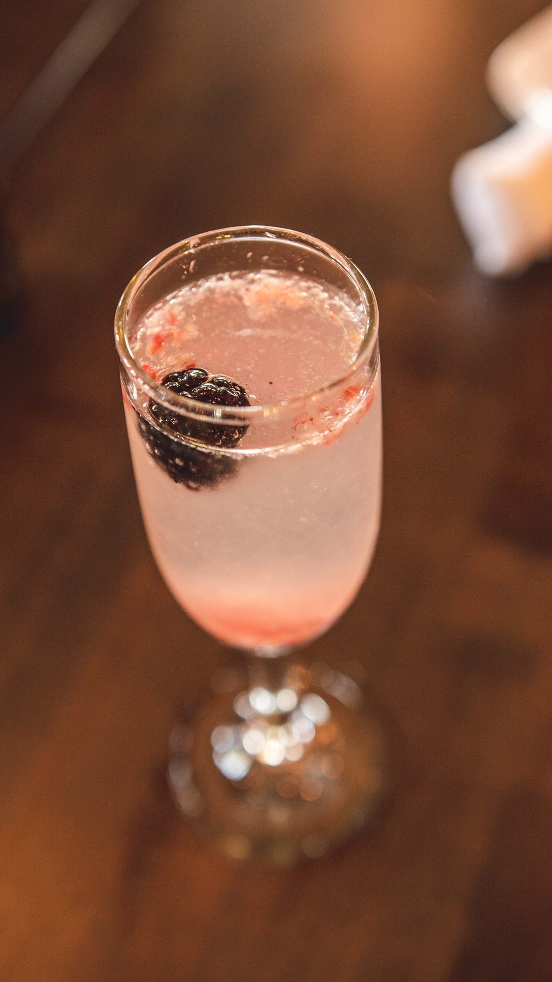 A pink sparkling drink in a flute
