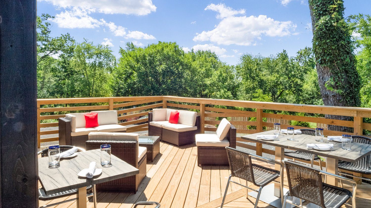 Cushioned lounge seating at one end of the patio