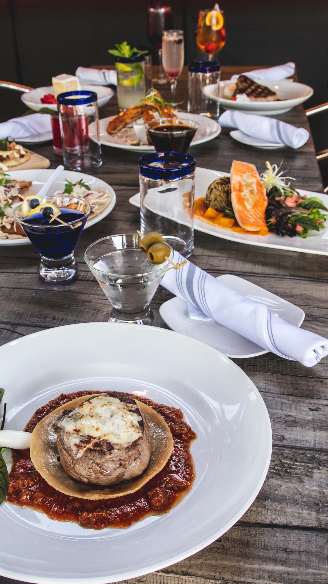 A table laid with several dishes and drinks